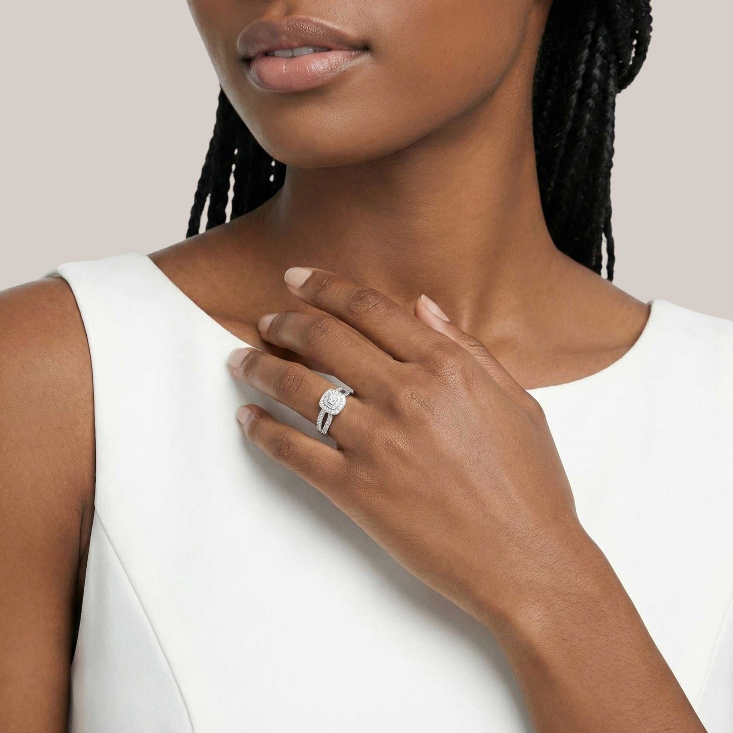 Woman wearing a diamond ring on a neutral background