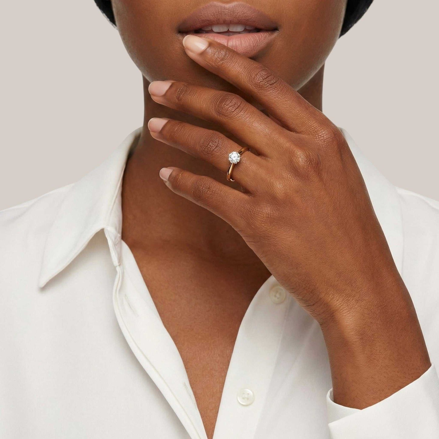 Close-up of a hand wearing a ring with a white background