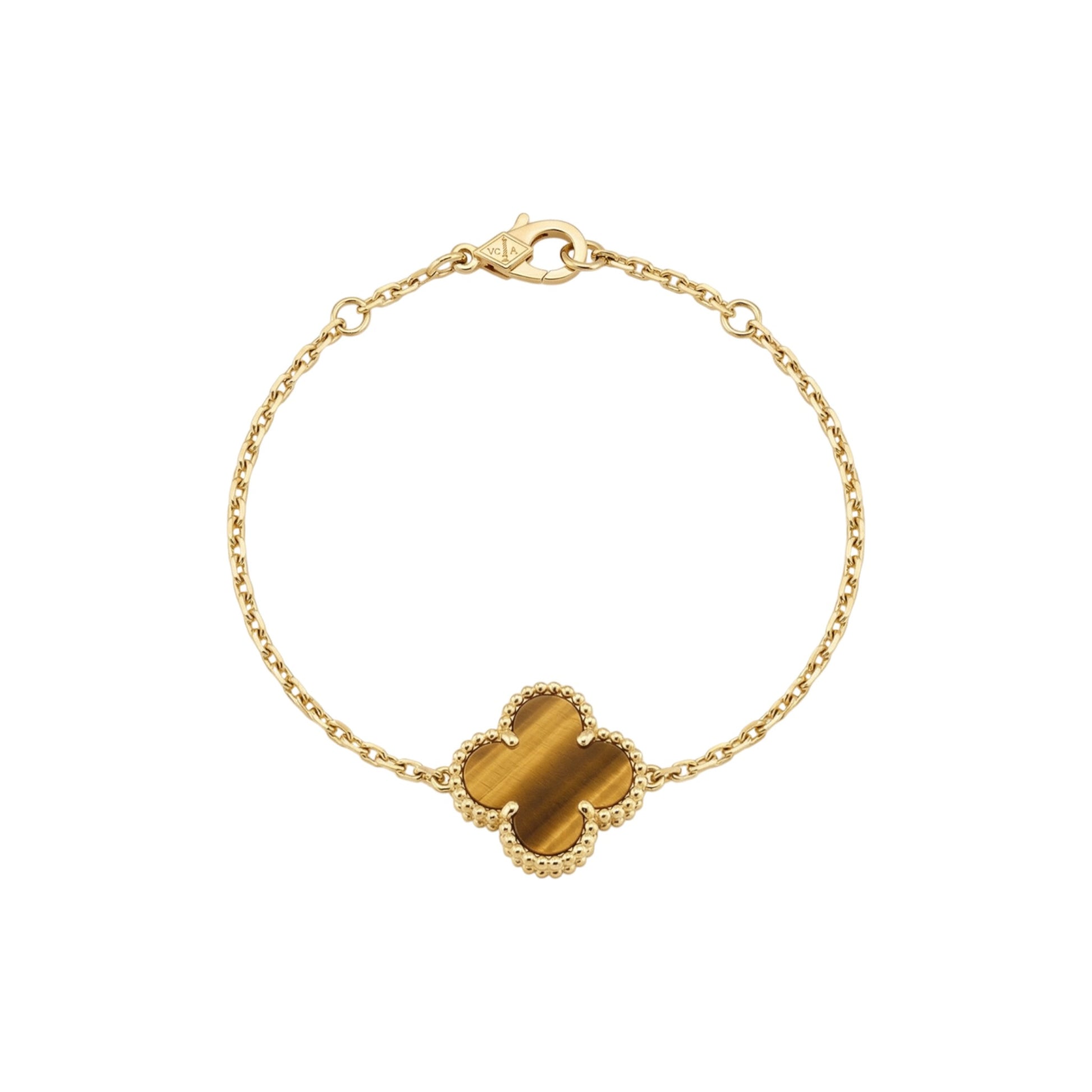 Gold bracelet with a tiger's eye stone on a white background