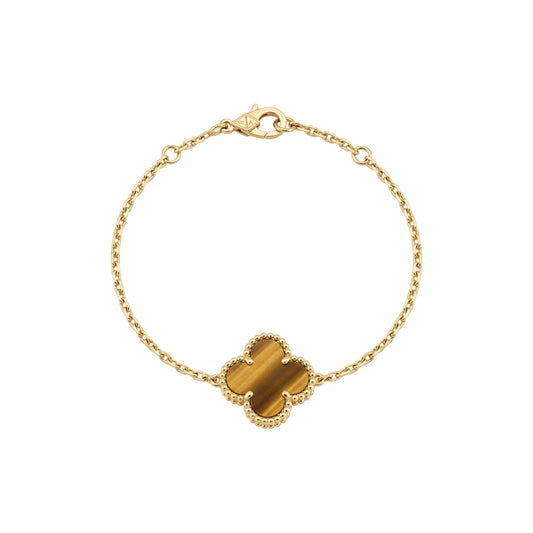 Gold bracelet with a tiger's eye stone on a white background