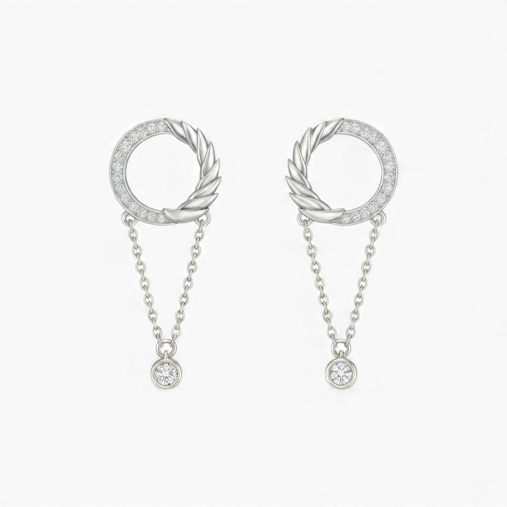 Pair of silver hoop earrings with chain drops on a white background