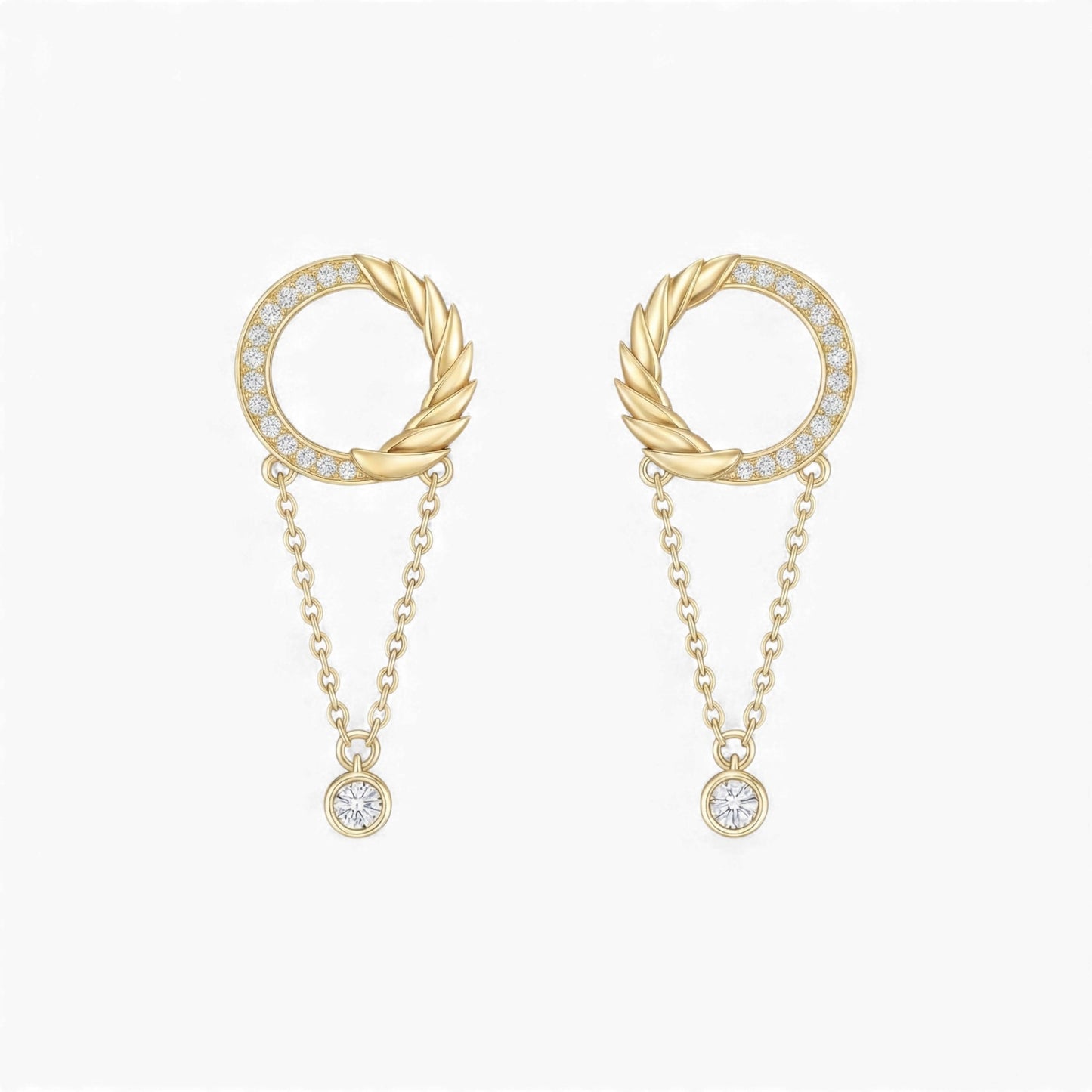 Gold earrings with circular designs and chain details on a white background