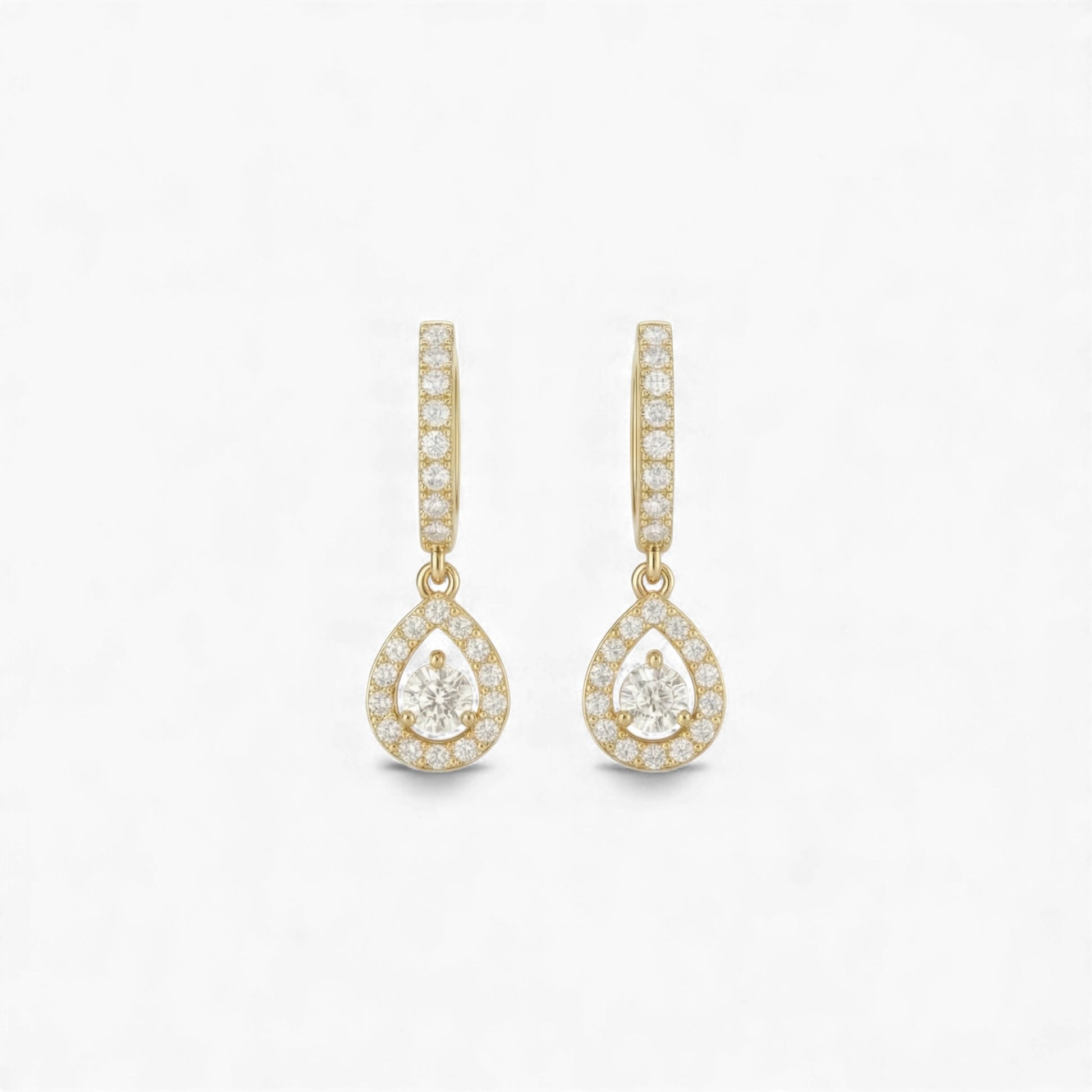 Gold teardrop earrings with clear gemstones on a white background
