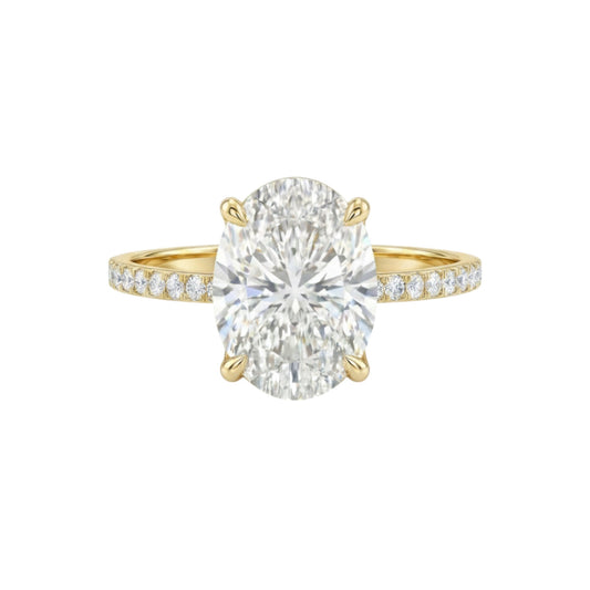 Gold ring with a large diamond and smaller diamonds on the band against a white background