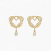 Gold heart-shaped earrings with diamond accents on a white background