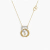 Gold and silver necklace with a unique pendant on a white background