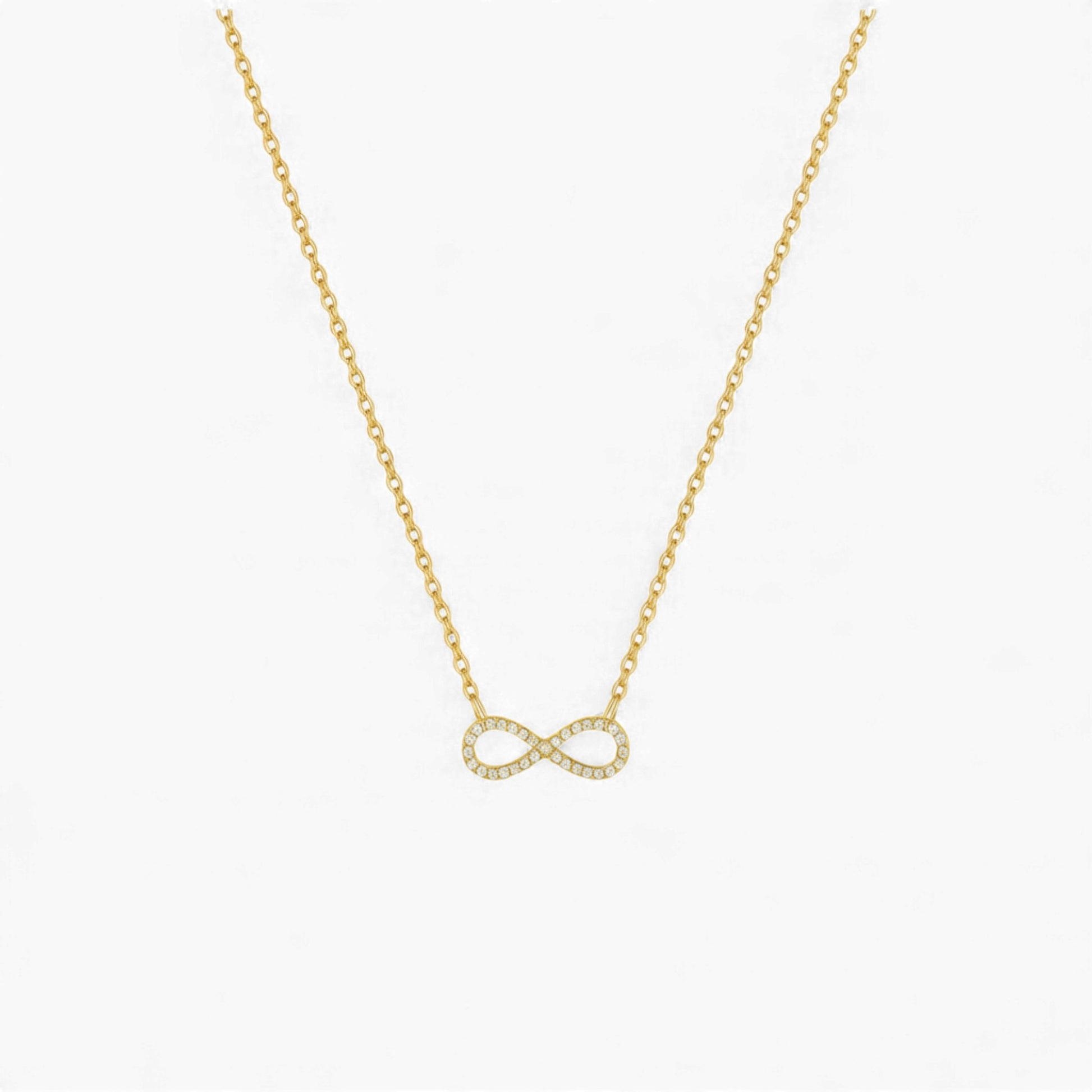 Gold infinity necklace on a white background
