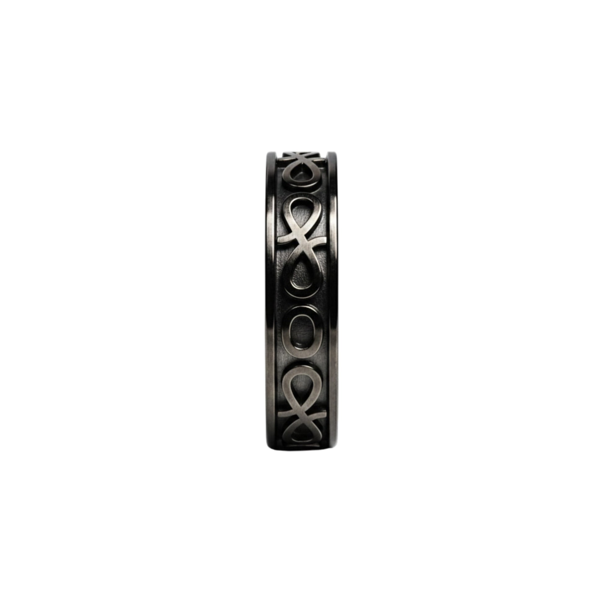 Black ring with intricate design on a white background