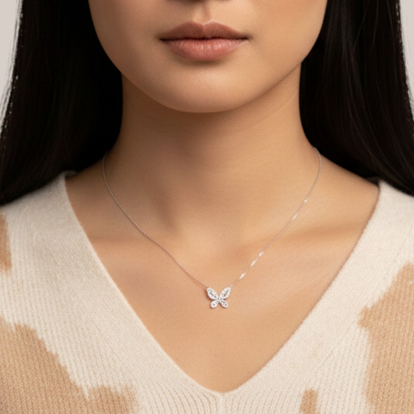 Butterfly necklace worn by a model against a neutral background