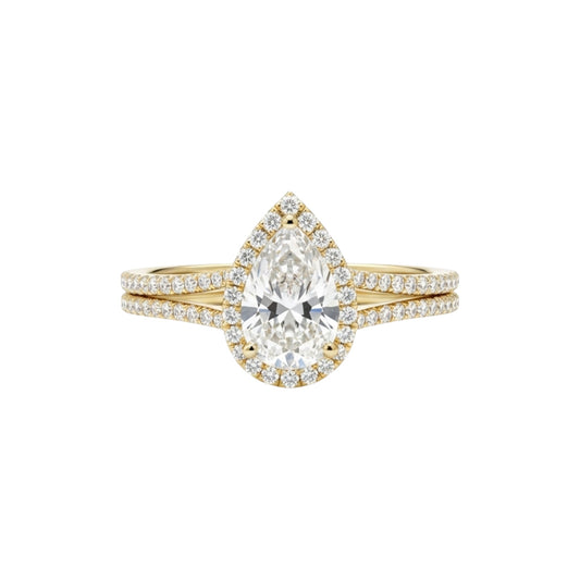 Gold ring with a pear-shaped diamond on a white background