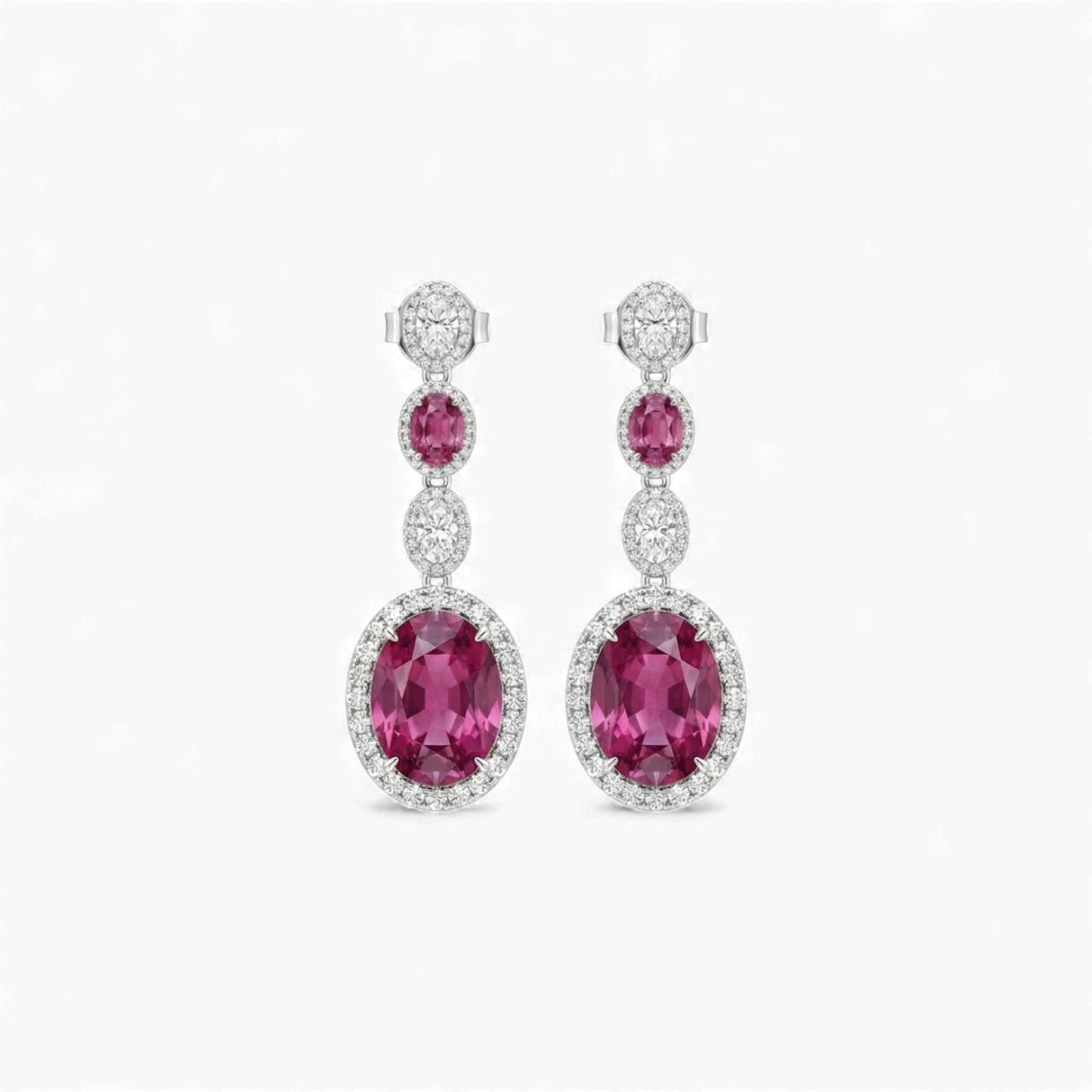 Pair of pink gemstone earrings with diamond accents on a white background