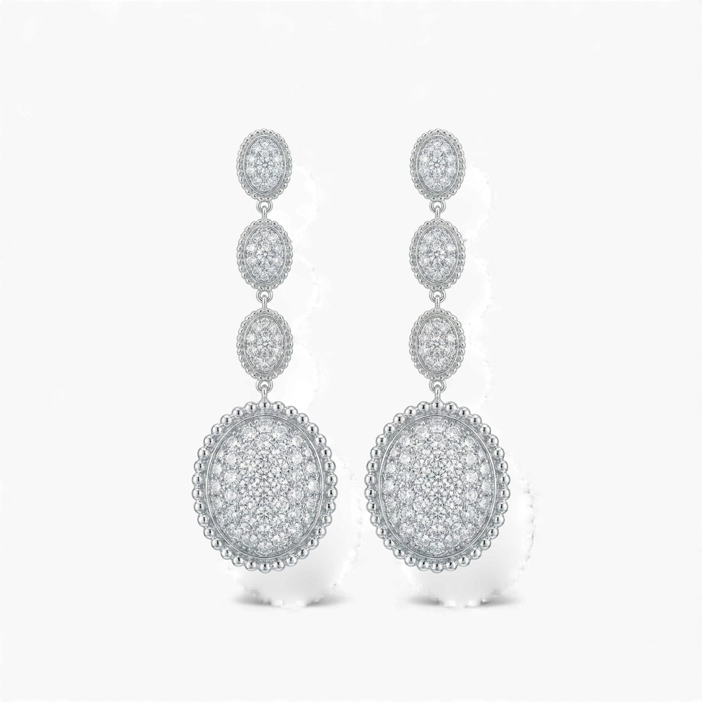 Pair of silver earrings with circular designs on a white background