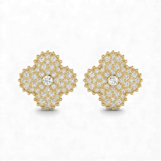 Gold earrings with diamond accents on a white background