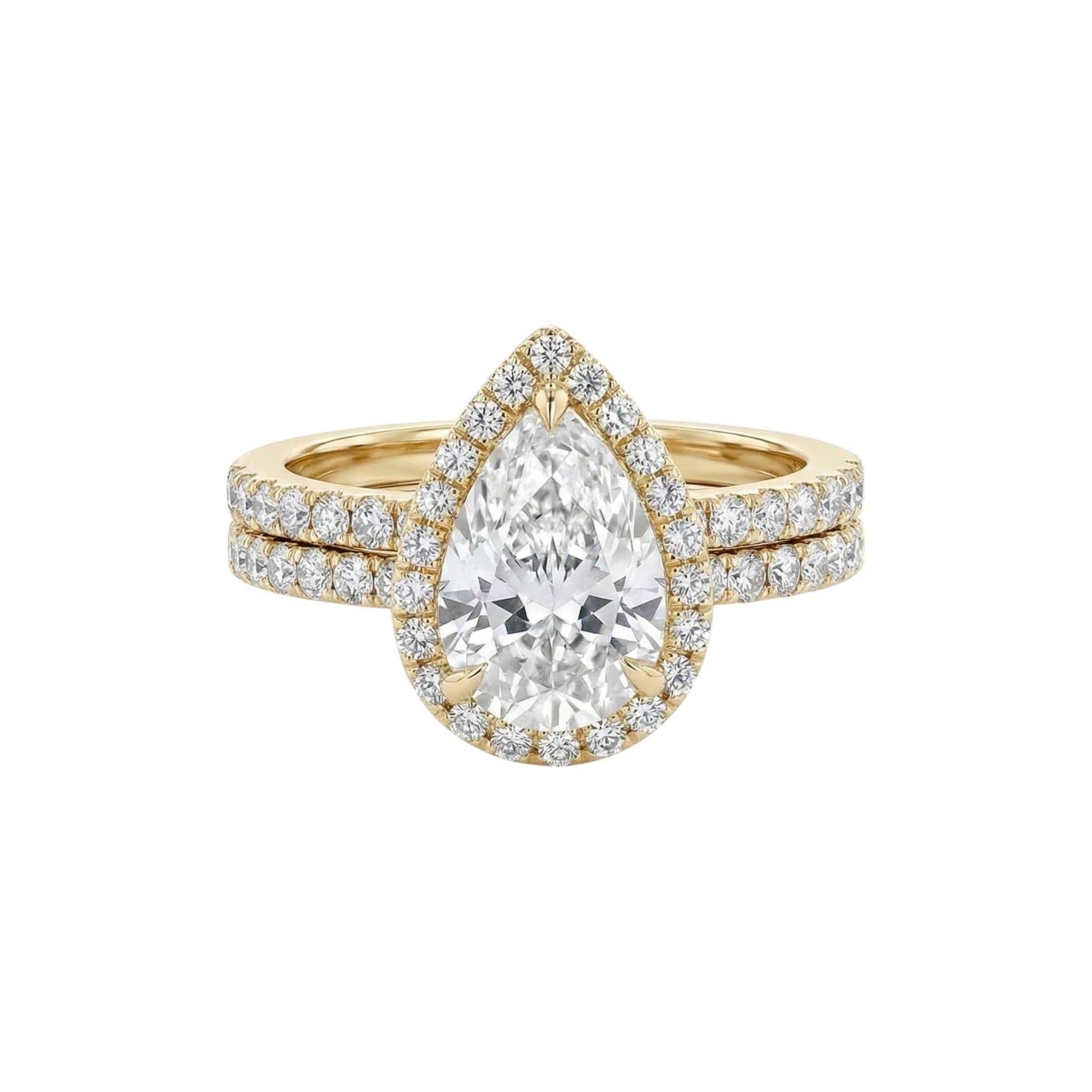 Ola Pear Cut Moissanite and natural diamond bridal set in 18KT gold ring with pavé diamond halo and matching band