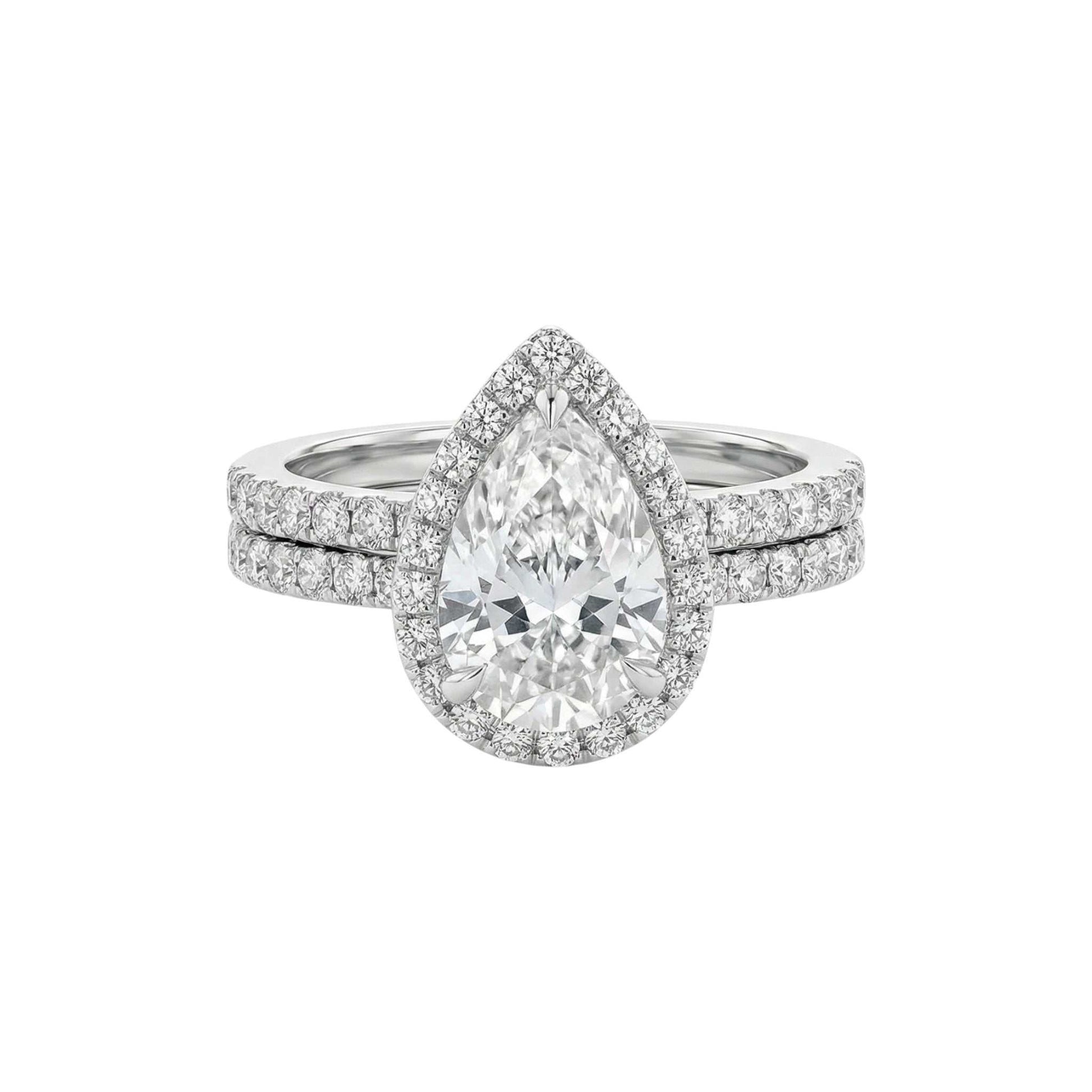 Diamond ring with a pear-shaped center stone on a white background