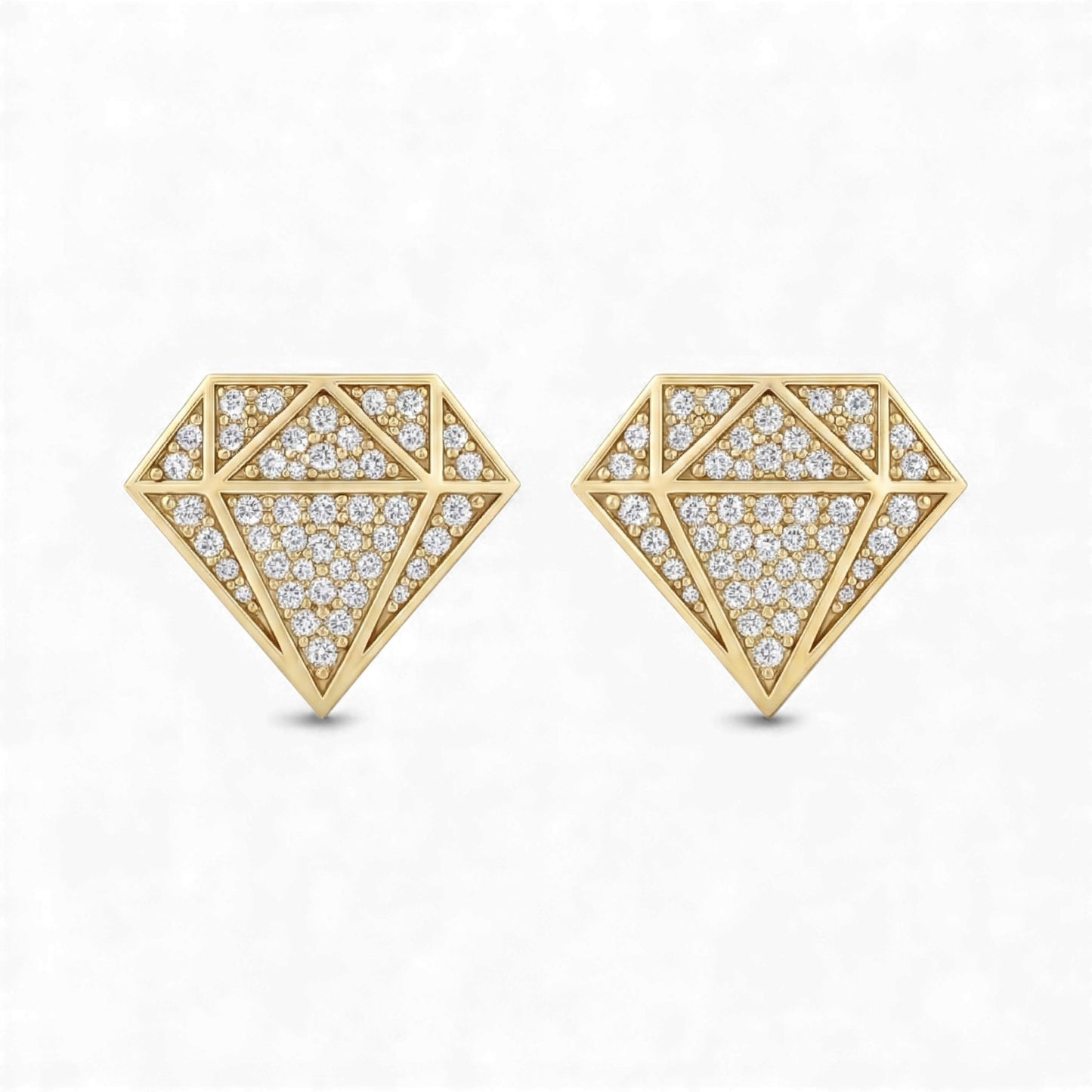 Gold geometric earrings with diamond-like stones on a white background