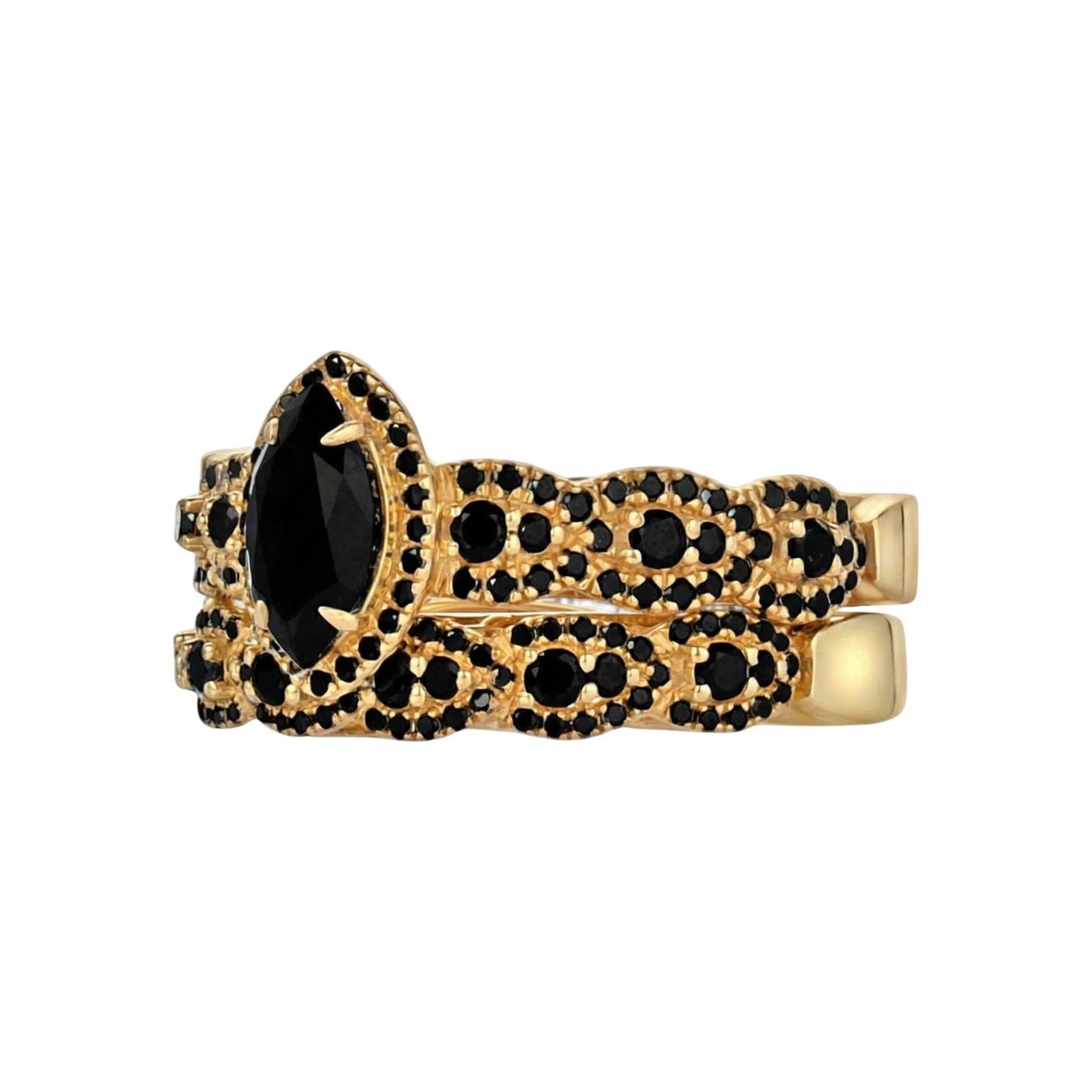 Gold ring with black gemstones on a white background