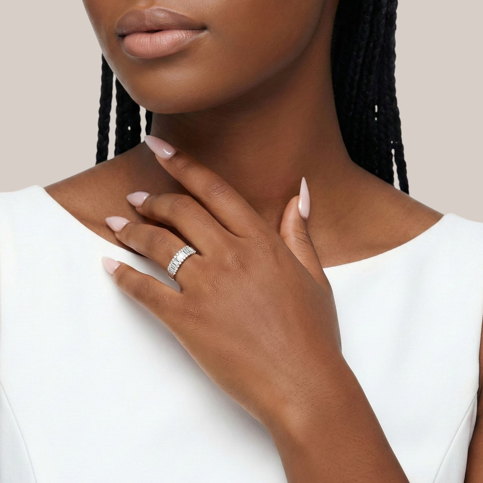 Close-up of a woman's hand wearing a ring with a white background
