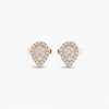 Heart-shaped earrings with rose gold and clear gemstones on a white background