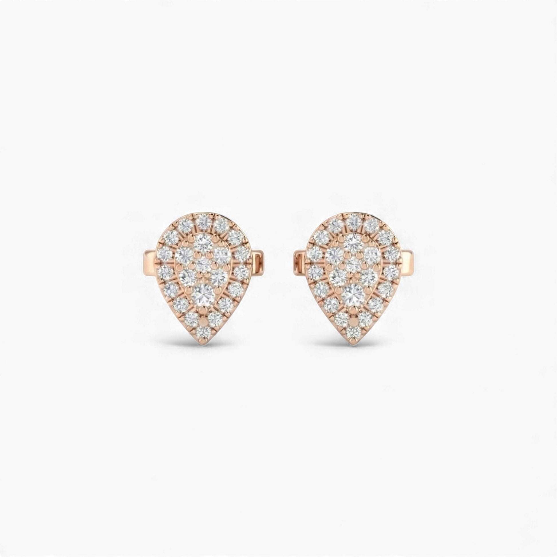 Heart-shaped earrings with rose gold and clear gemstones on a white background