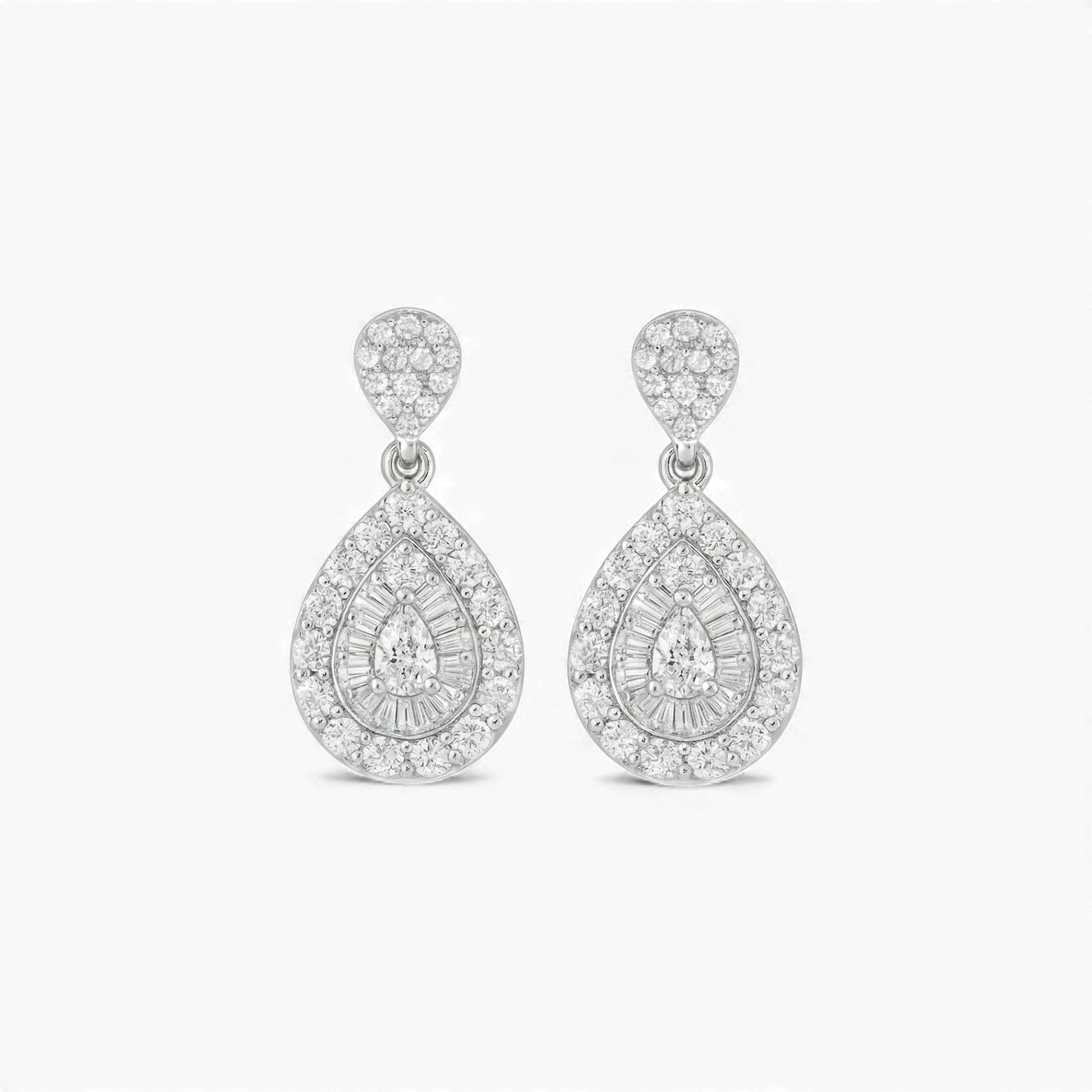 Pair of silver teardrop earrings with clear gemstones on a white background