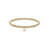 Gold beaded bracelet with a round tag on a white background