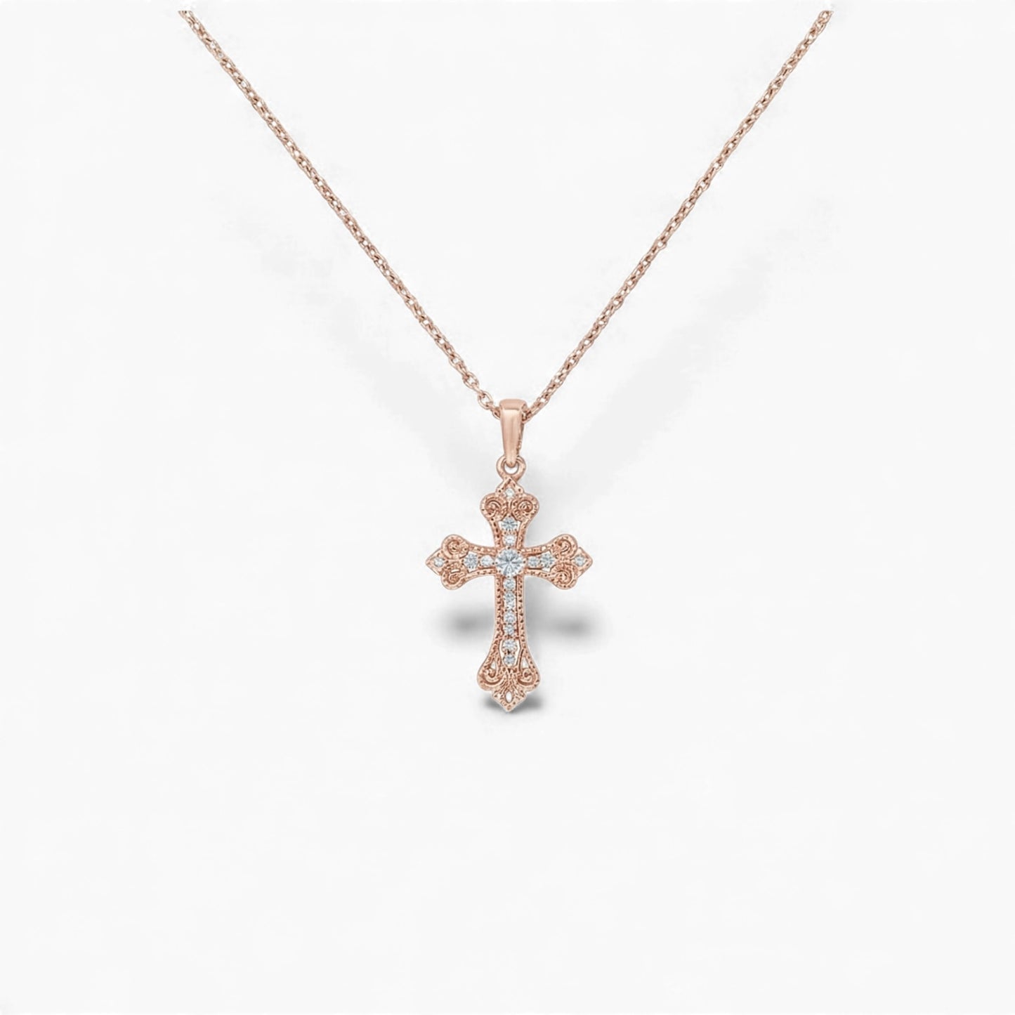 Rose gold cross necklace on a white background