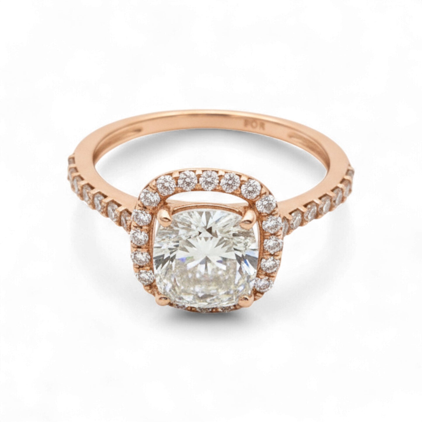 Rose gold ring with a large diamond and smaller diamonds around on a white background