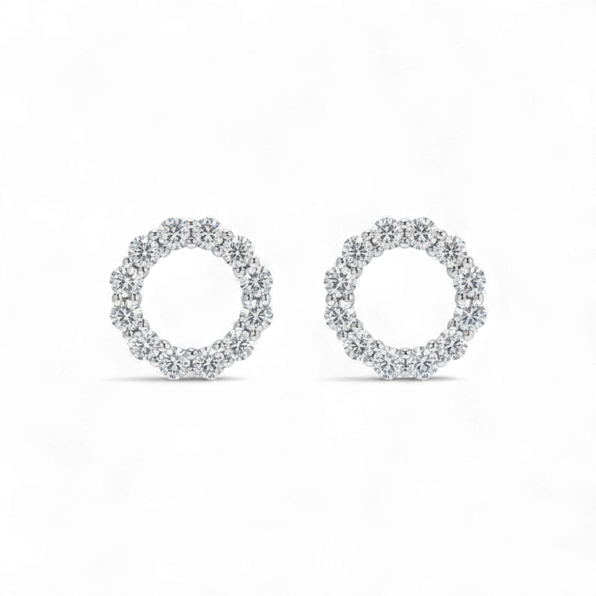 Pair of silver hoop earrings on a white background