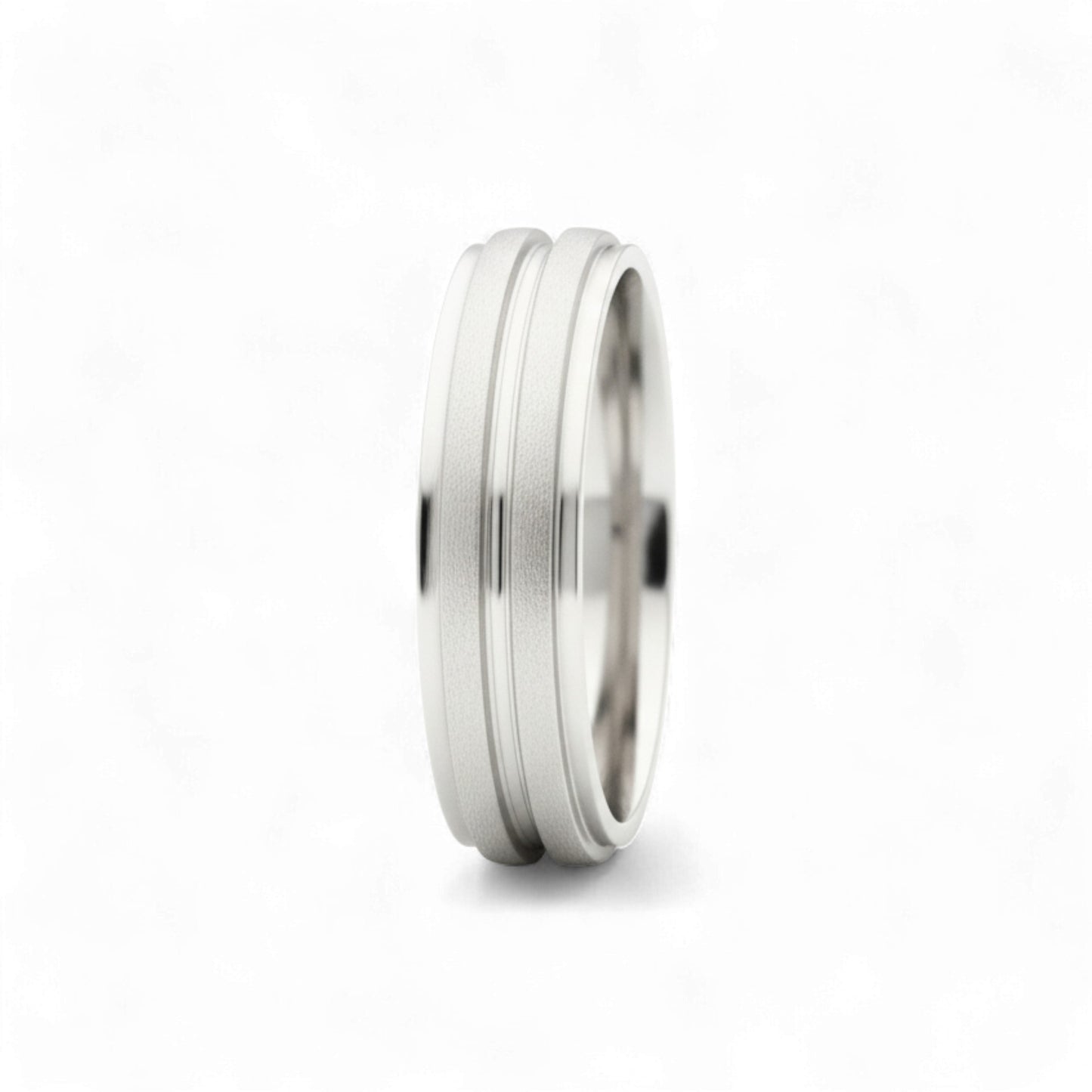 Silver ring with a textured band on a white background