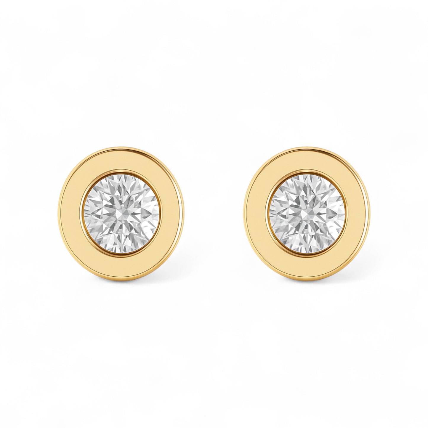 Gold earrings with clear gemstones on a white background