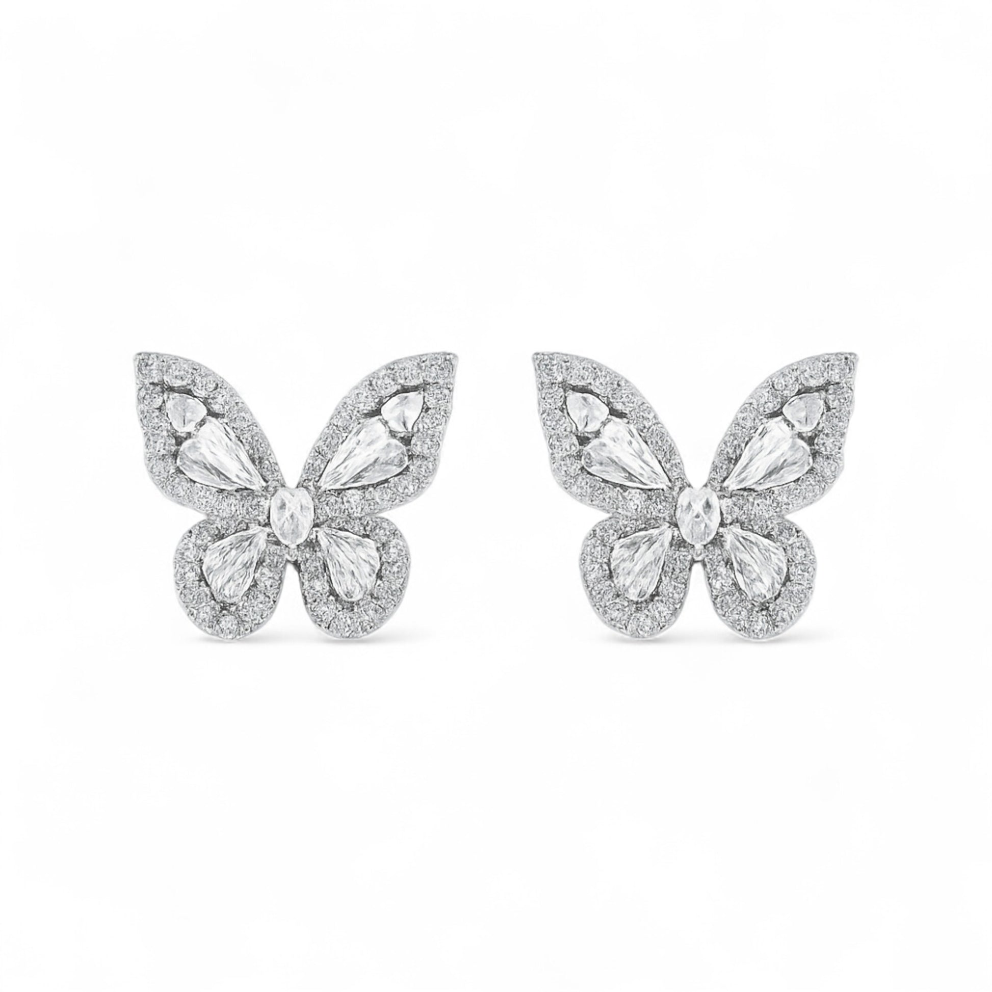 Butterfly-shaped earrings with gemstones on a white background