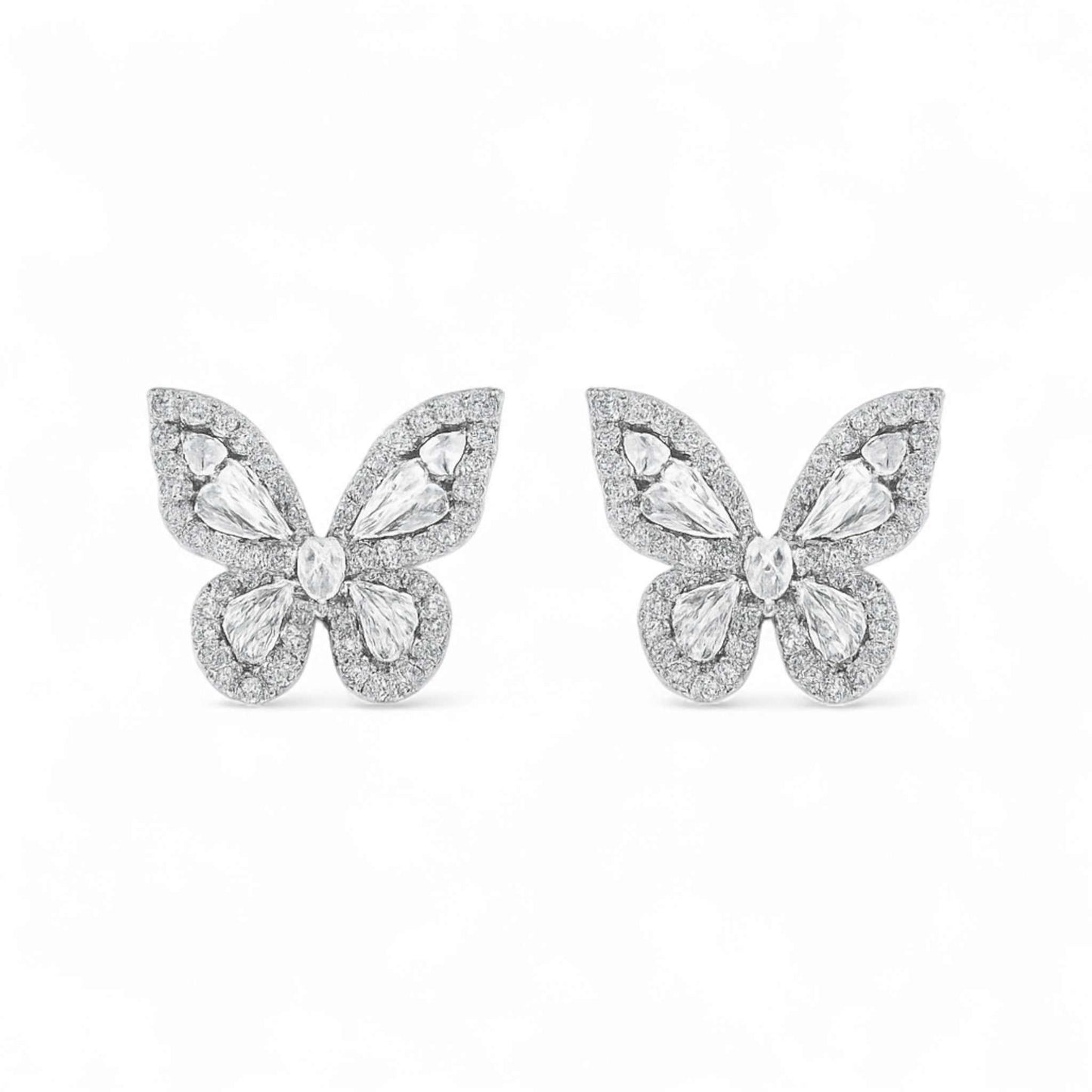Butterfly-shaped earrings with gemstones on a white background