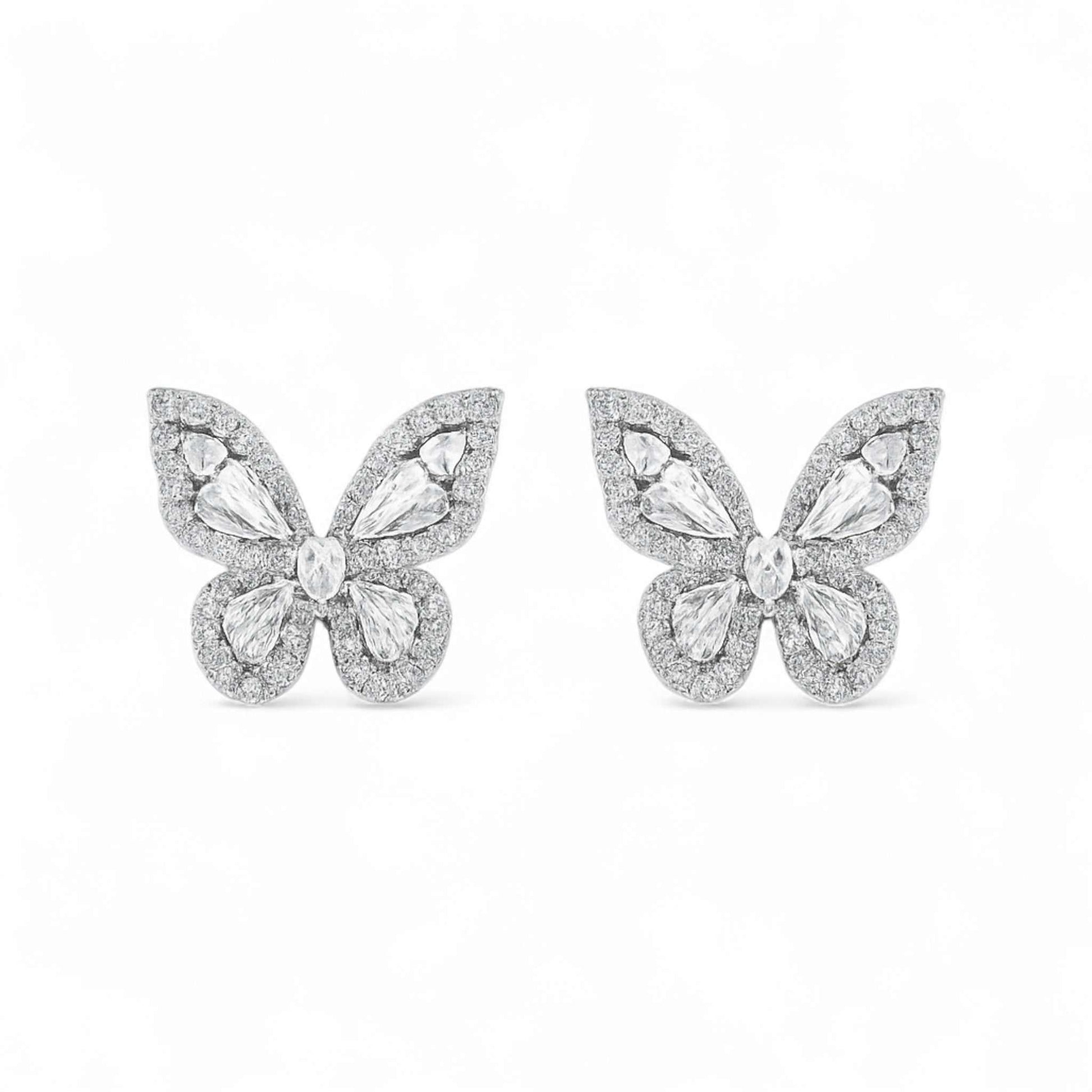 Butterfly-shaped earrings with gemstones on a white background