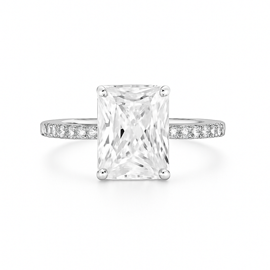 Diamond ring with a rectangular center stone on a white background