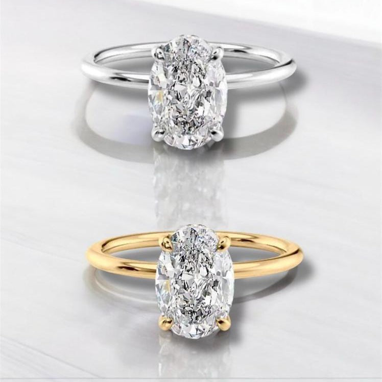 Two diamond rings, one gold and one silver, on a light background