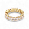 Gold ring with clear gemstones on a white background