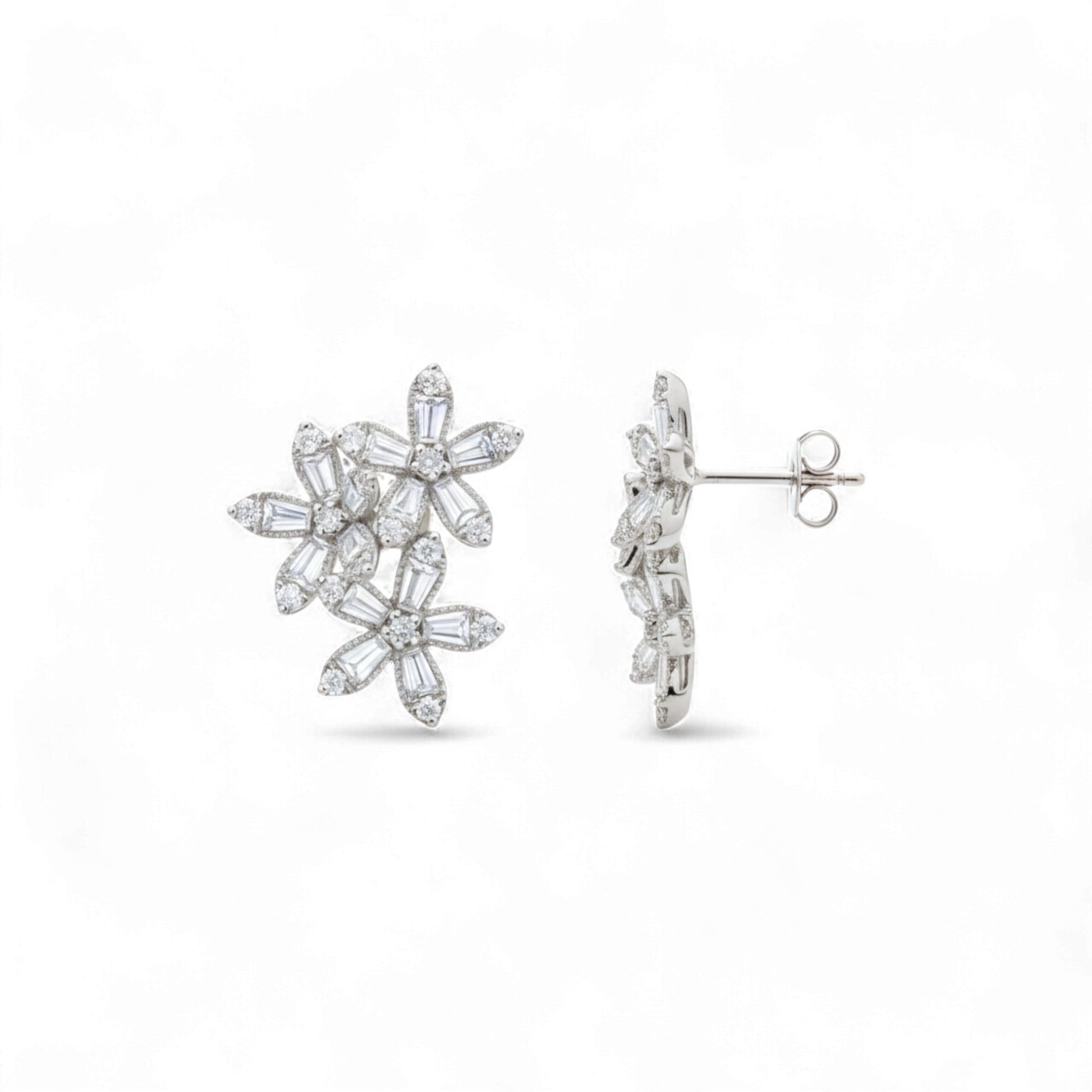 Pair of silver floral earrings on a white background
