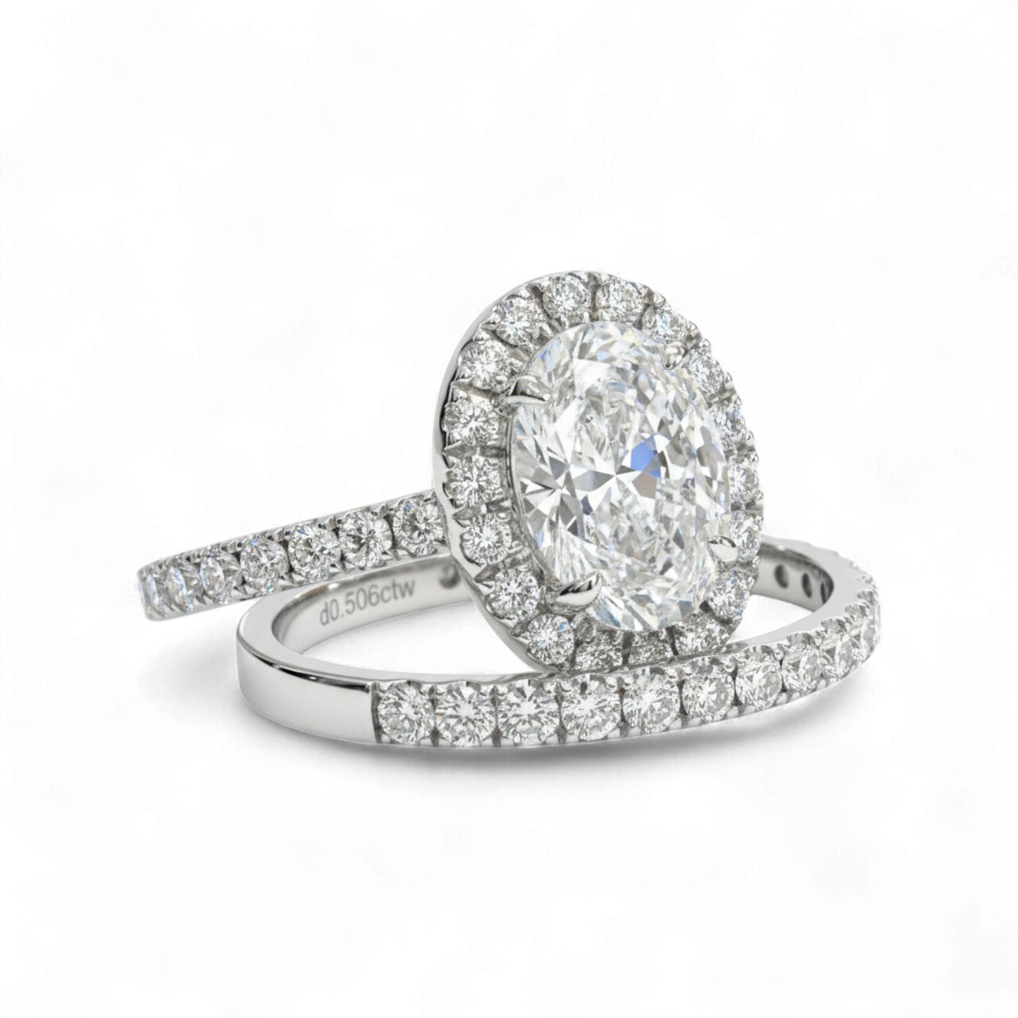 Diamond ring with a halo and smaller diamonds on a white background