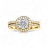 Gold ring with a large diamond and smaller diamonds on the band against a white background