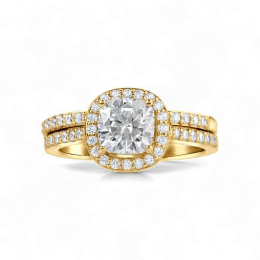 Gold ring with a large diamond and smaller diamonds on the band against a white background