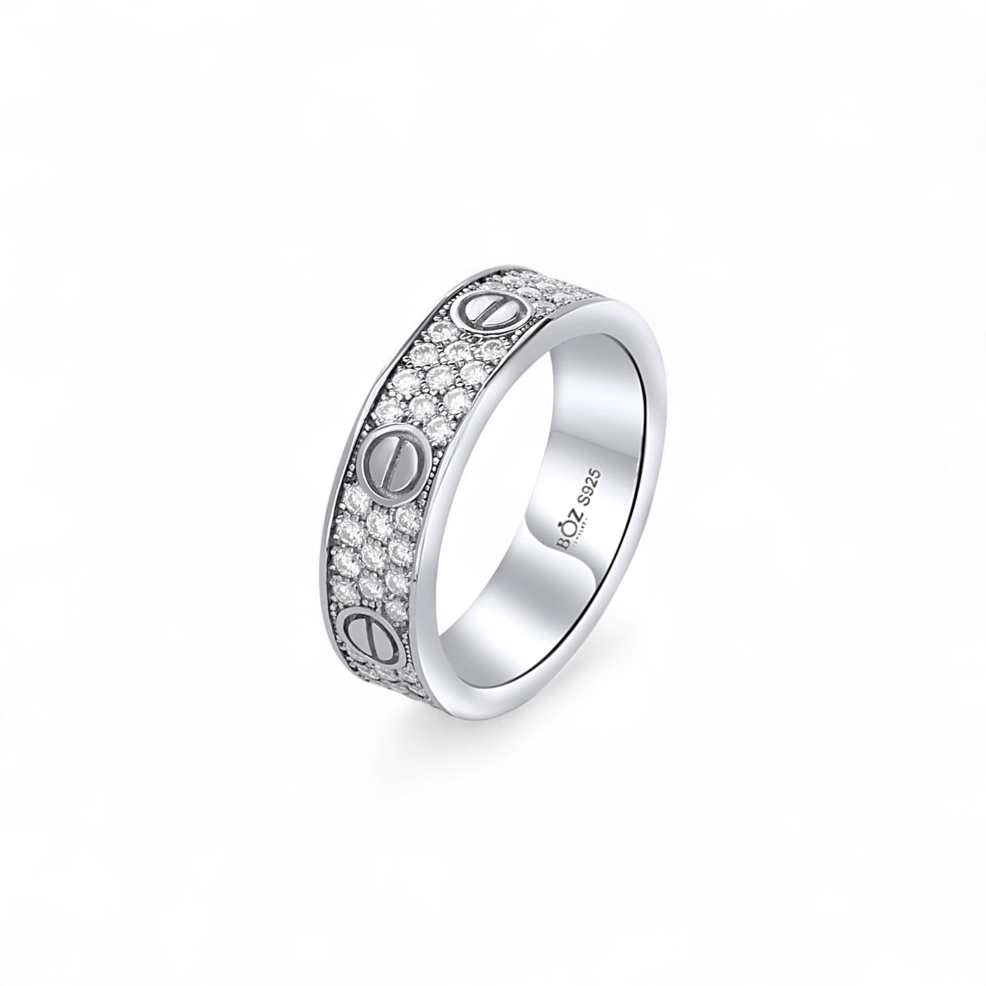 Silver ring with engraved symbols on a white background