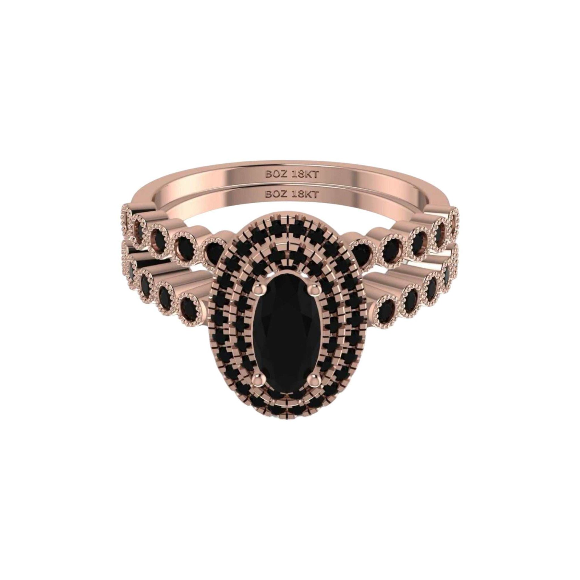 Rose gold ring with black gemstone on a white background