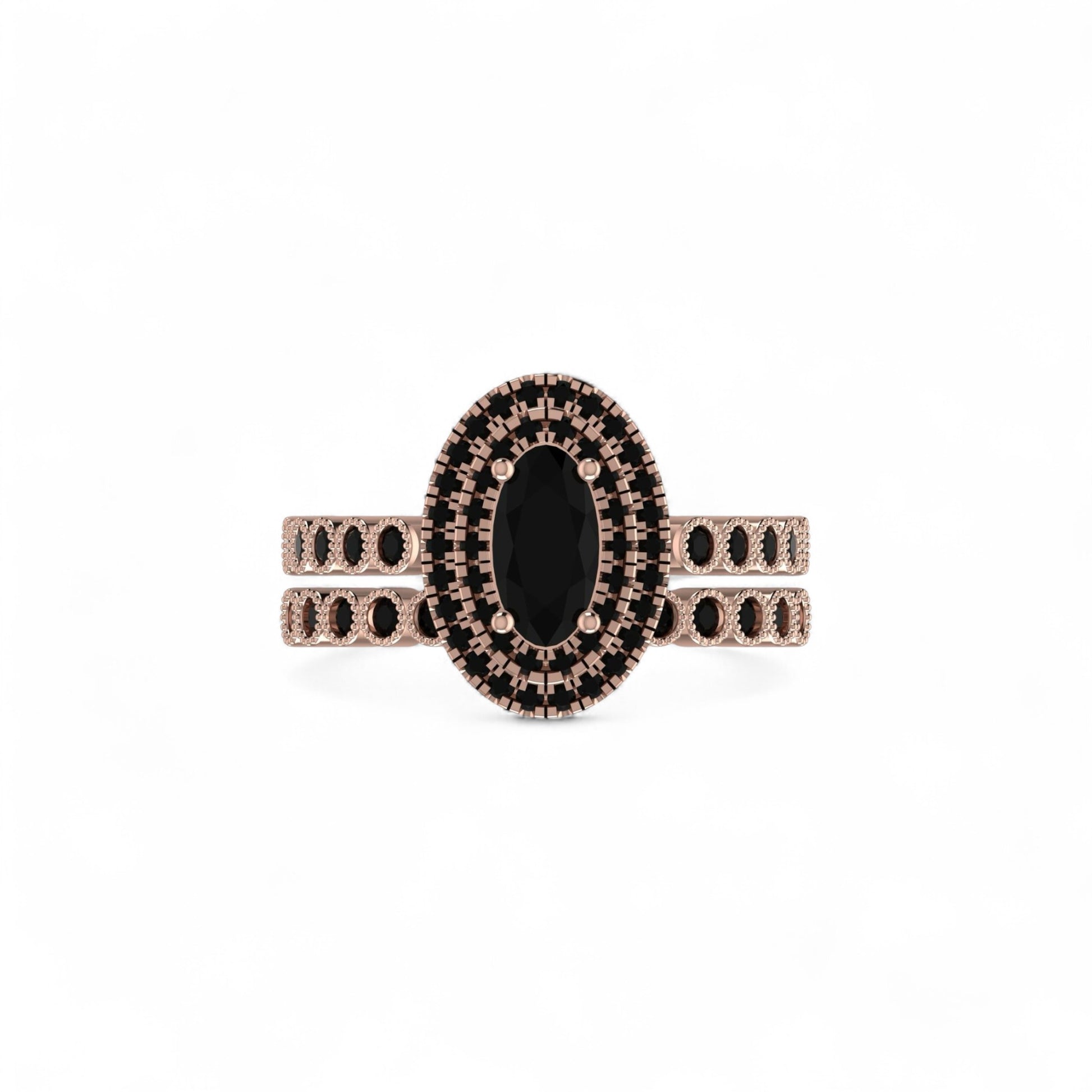 Rose gold ring with black gemstone on a white background