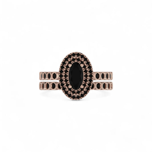 Rose gold ring with black gemstone on a white background