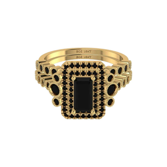 Gold ring with a black gemstone on a white background