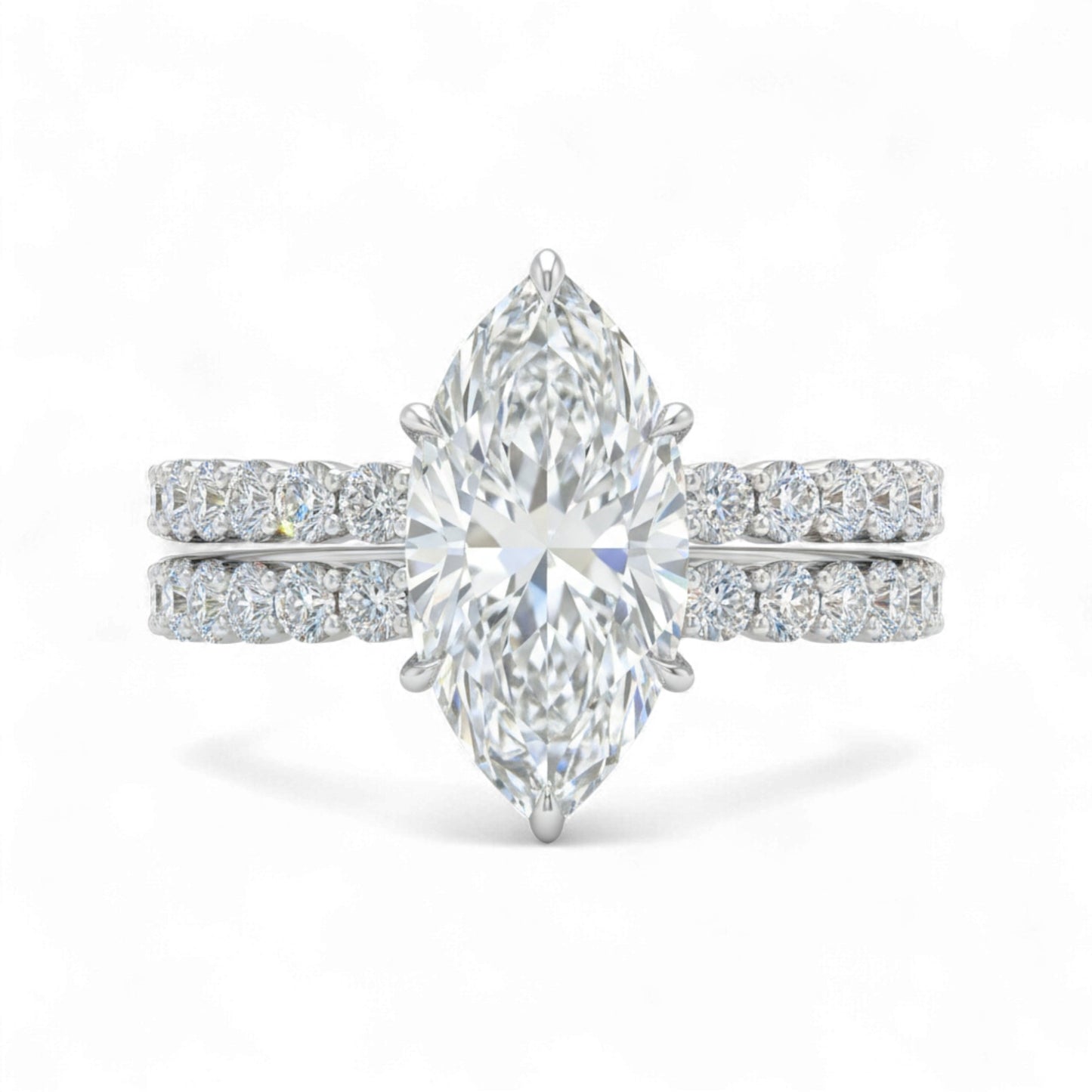 Diamond ring with pear-shaped center stone on a white background