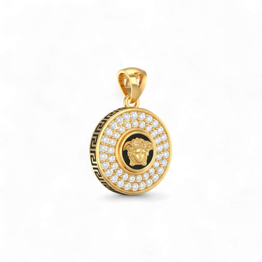 Gold pendant with a black and gold emblem on a white background