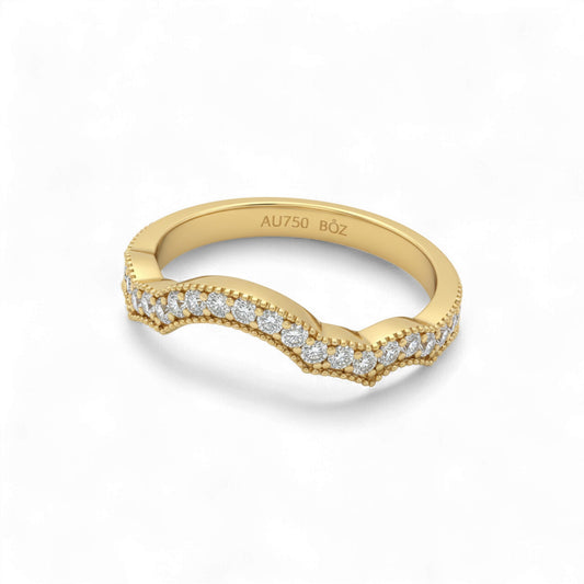 Gold ring with diamond accents on a white background