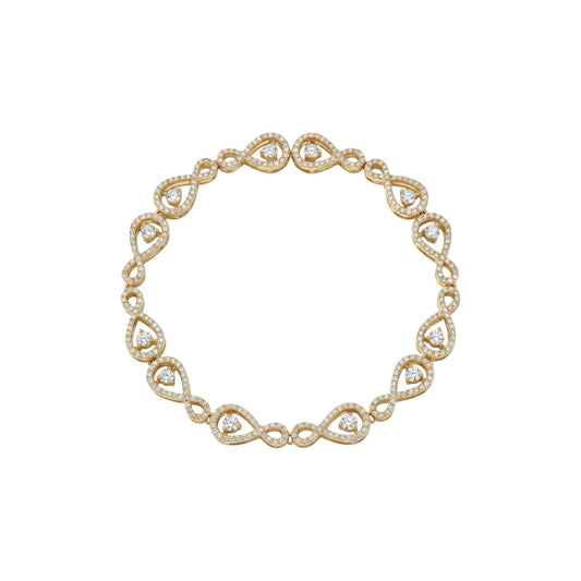 Gold bracelet with heart-shaped gemstones on a white background